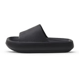 A black slipper with a thick sole, designed for comfort and support.